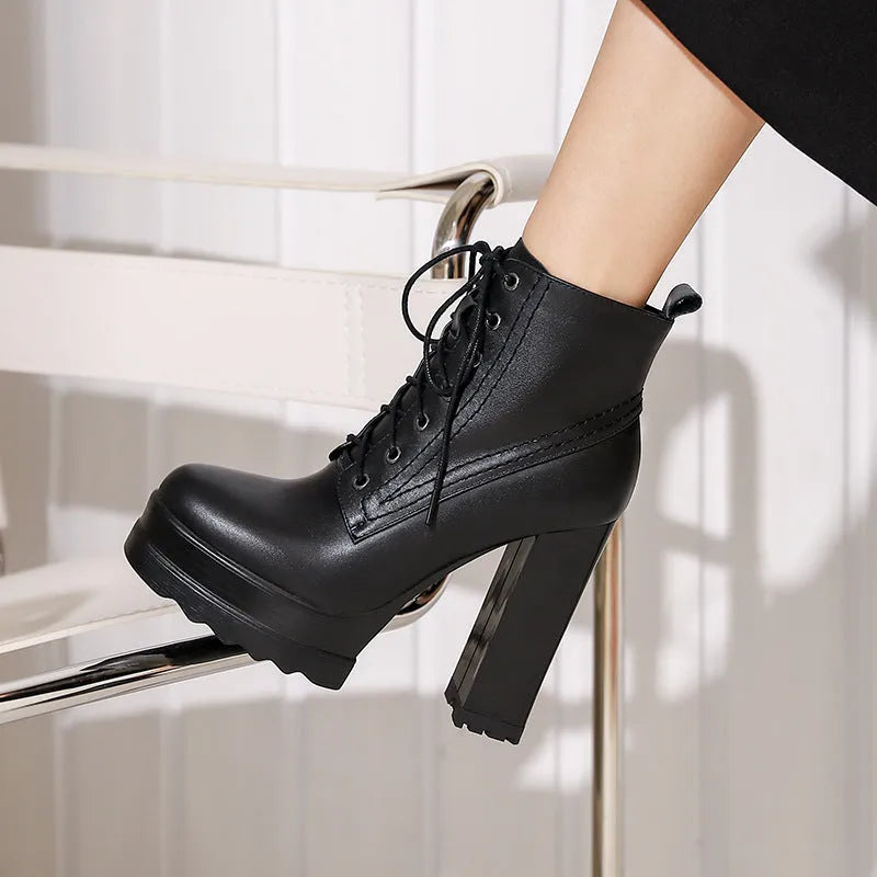 Women's black chunky heel waterproof platform boots with a side zipper on a cowhide upper.