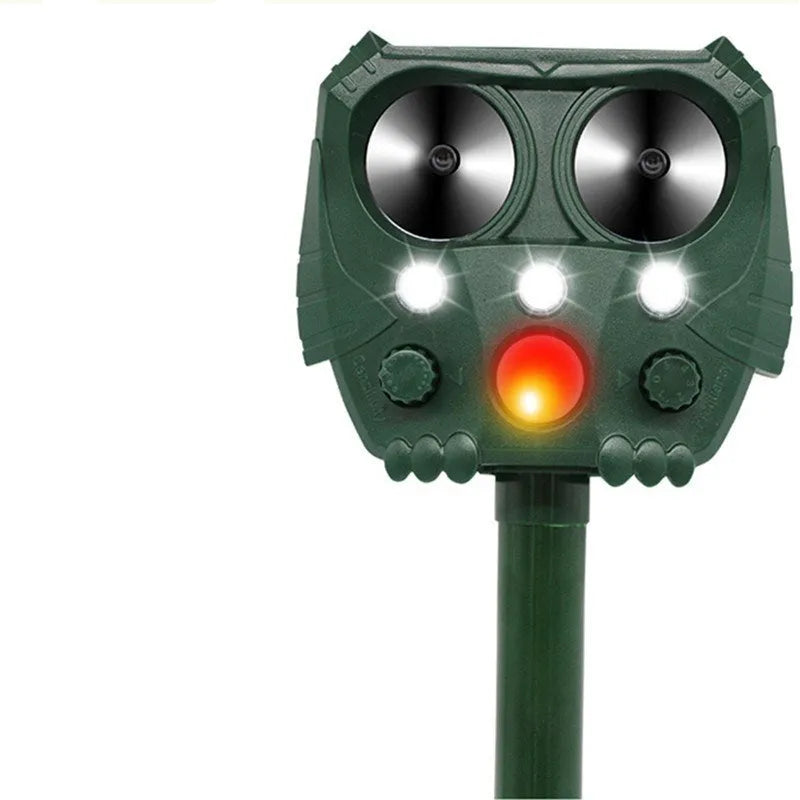 Green solar-powered ultrasonic animal repeller unit with LED light for outdoor pest control.