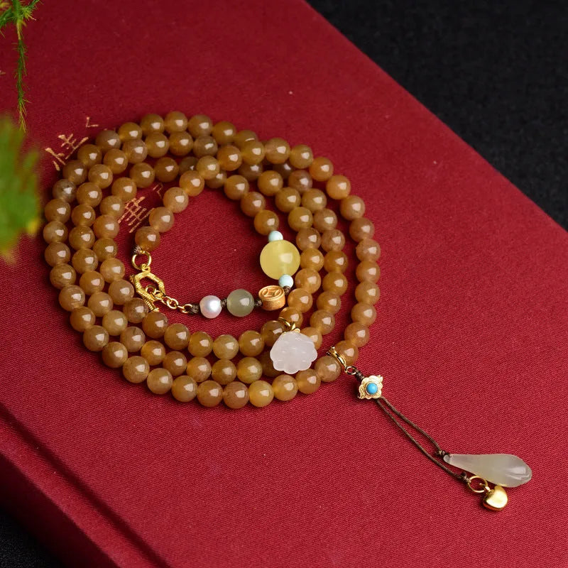 Green pine jade bracelet with 6mm round beads, leaf charms, and sequin accents on wrist