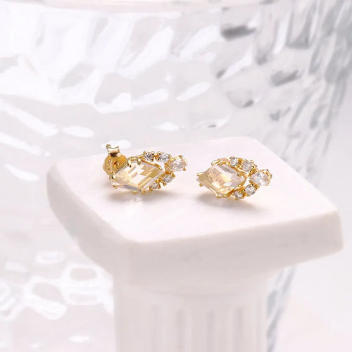 Geometric 925 silver ear studs with natural white crystal accents on simple background