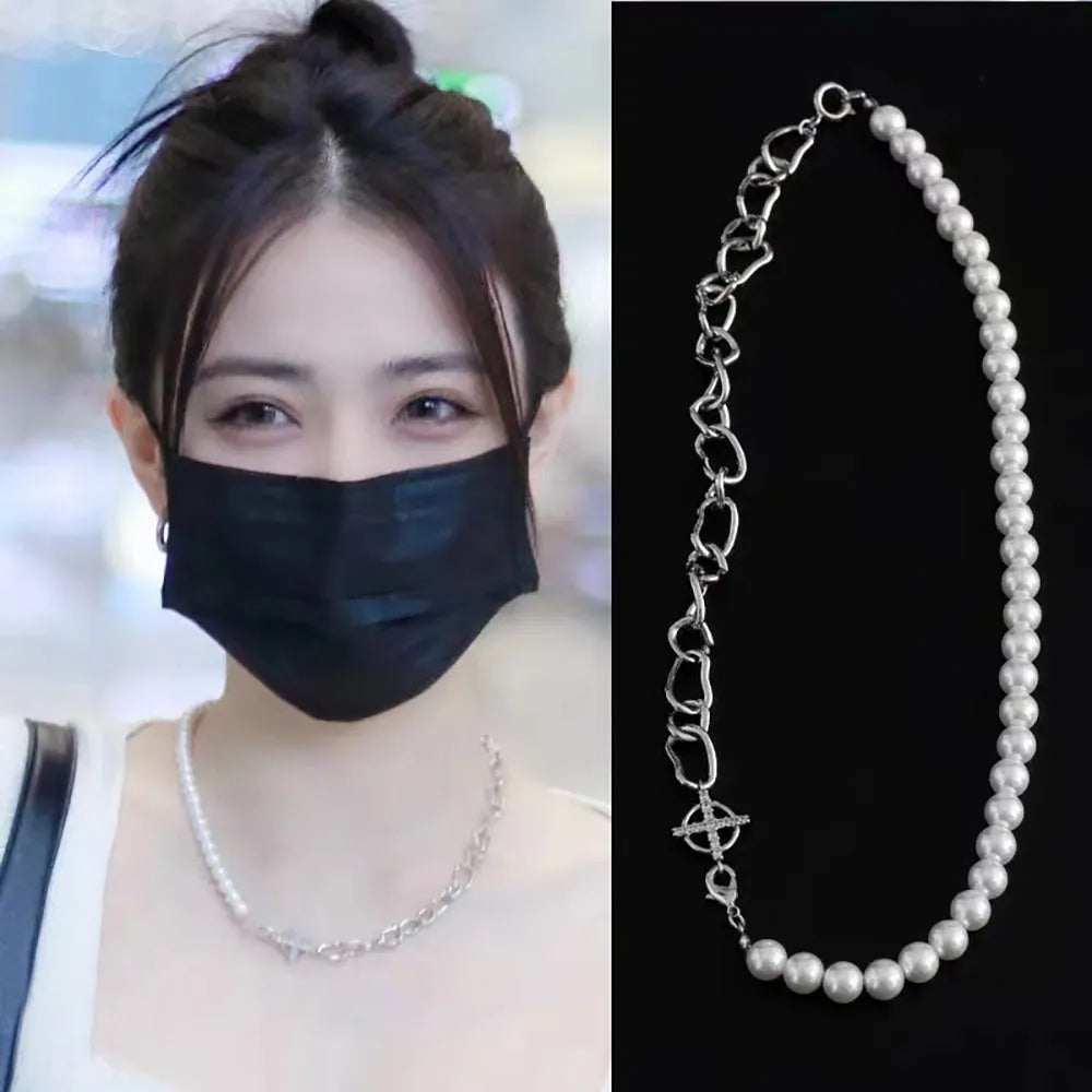White acrylic geometric asymmetric pendant necklace on a twisted chain, shown at clavicle length.