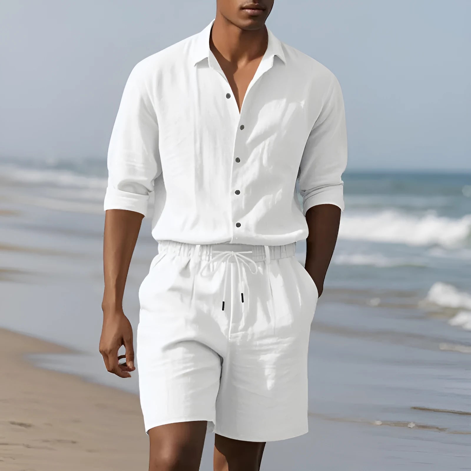 Men's linen beach suit consisting of a long sleeve shirt and shorts, shown in light blue colour.