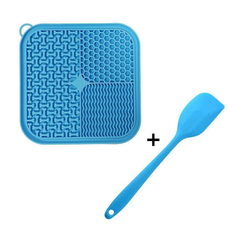 Orange, grey, blue and green silicone dog licking mat with suction cups on back measuring 20x20cm