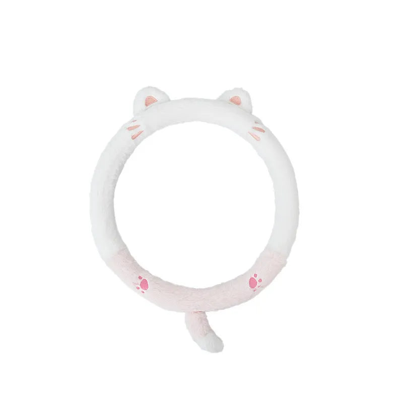 Plush rabbit fur style steering wheel cover with embroidered panda design, fitted on a car wheel