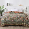Cotton gauze towel blanket with tassel edging in neoclassical floral pattern, available in 150x200cm and 200x230cm.