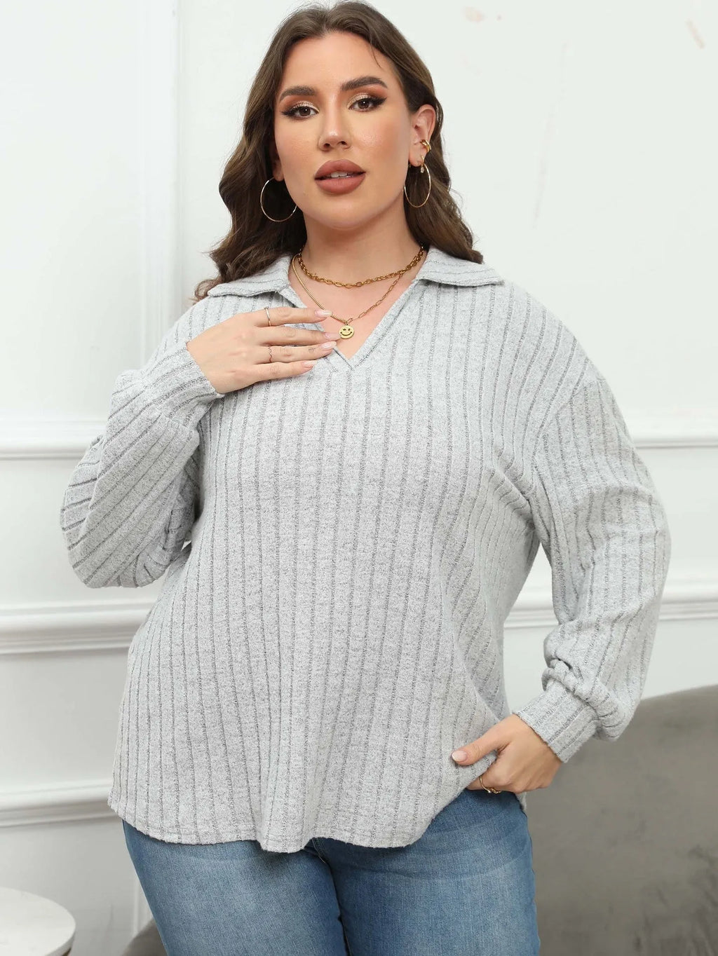 Women's plus size grey polo collar fleece shirt with lantern sleeves laid flat.