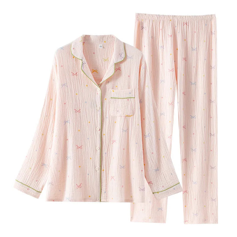 Women's beige thin cotton long sleeve pajama top and trousers set laid flat.
