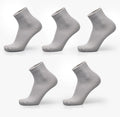 Men's bamboo fibre socks in black, navy, silver, iron grey, and grey blue with small square pattern.