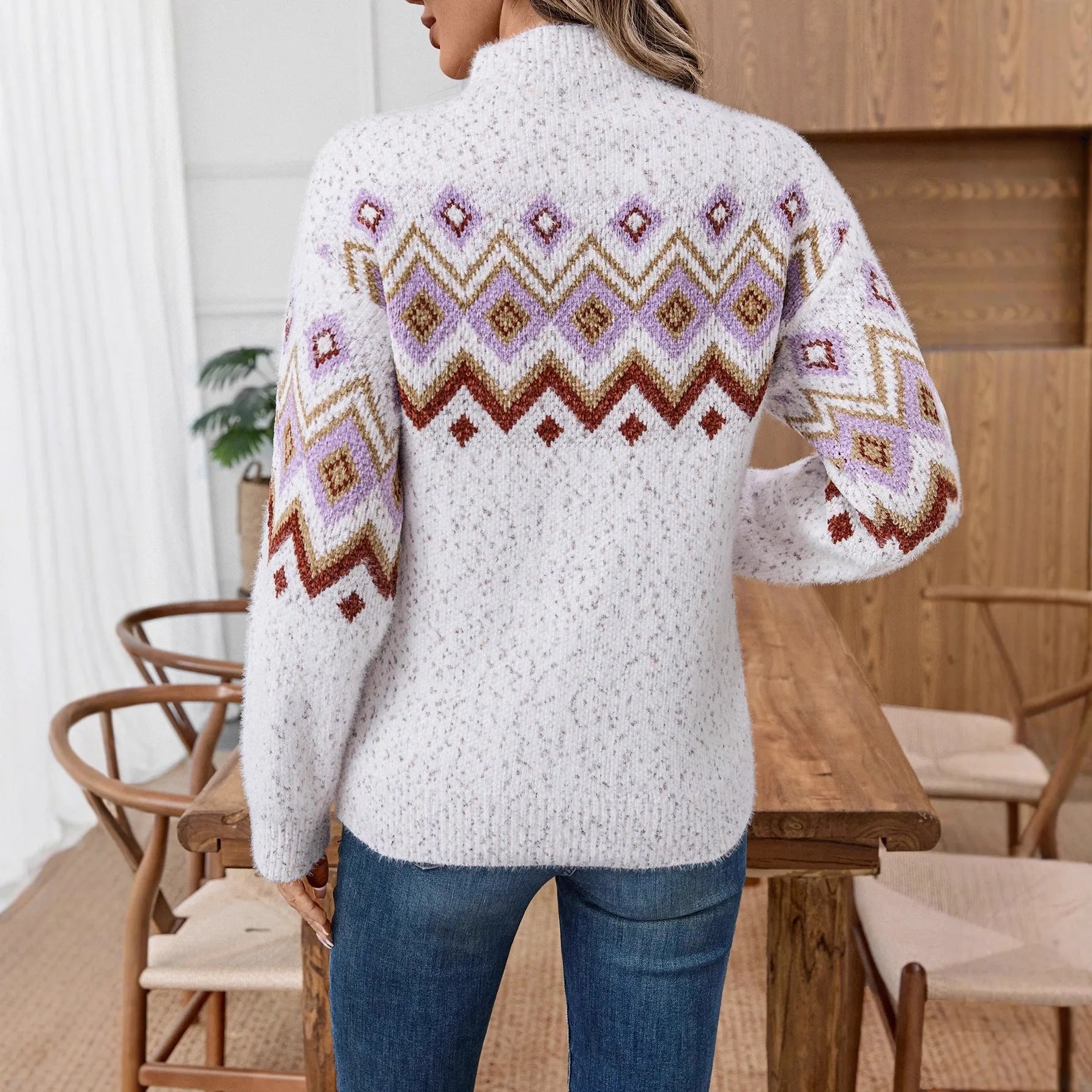 White loose fit women's sweater with a geometric jacquard pattern and a half turtleneck neckline.