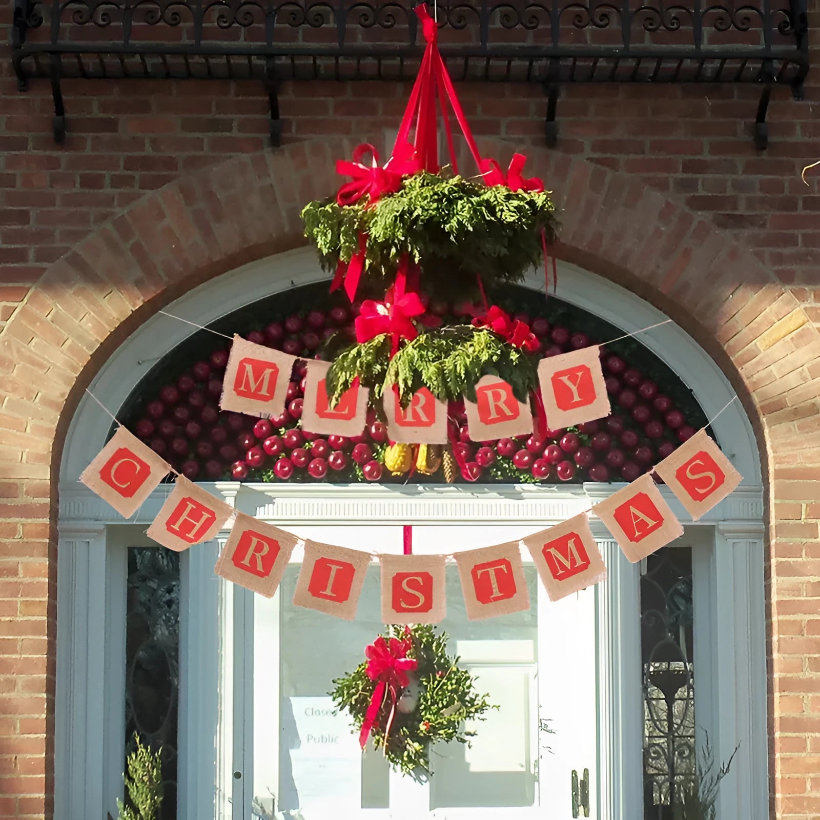 Two brown and red burlap Christmas banners with sackcloth flags hanging against a rustic backdrop.