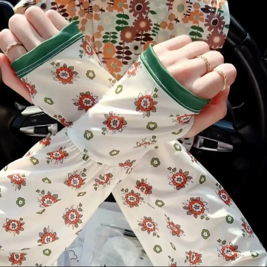 A pair of printed viscose sun protection oversleeves in a floral design on a mannequin arm.