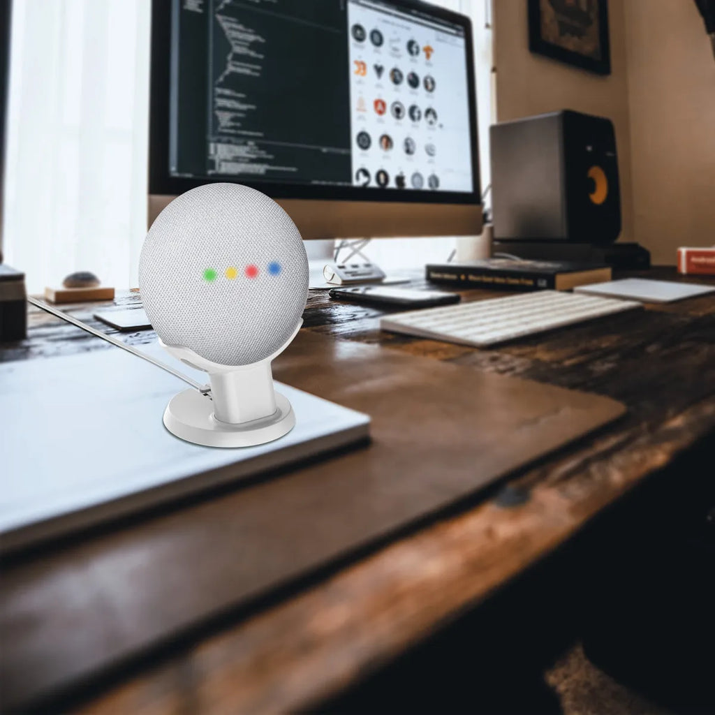 Black PlusAcc Google Home Mini stand holder on a wooden desk.