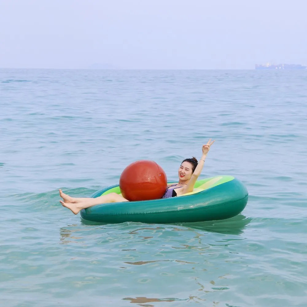 Green avocado-shaped inflatable pool float measuring 169cm long on blue water