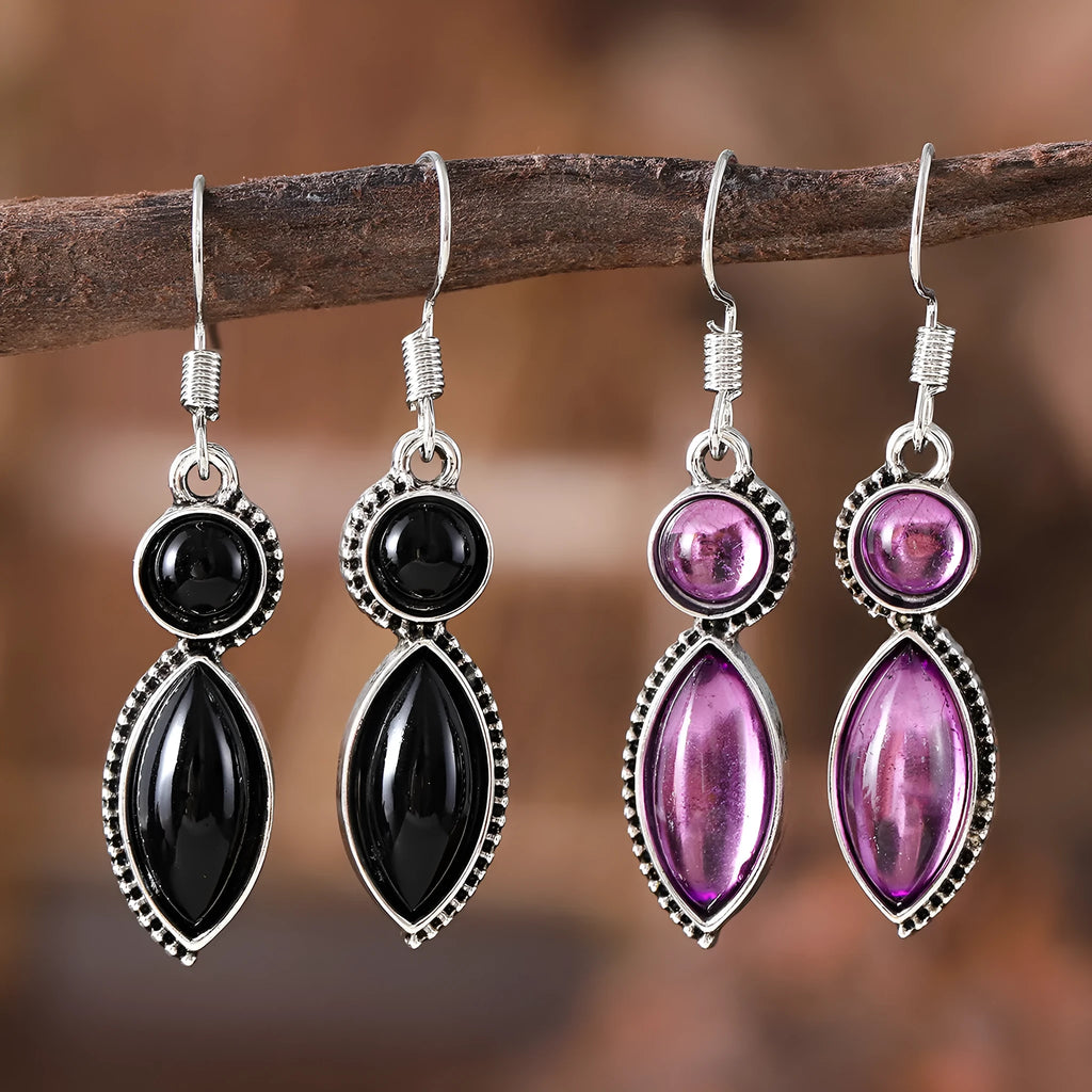 A pair of vintage-style geometric pendant earrings with purple and black stones on a zinc alloy frame.