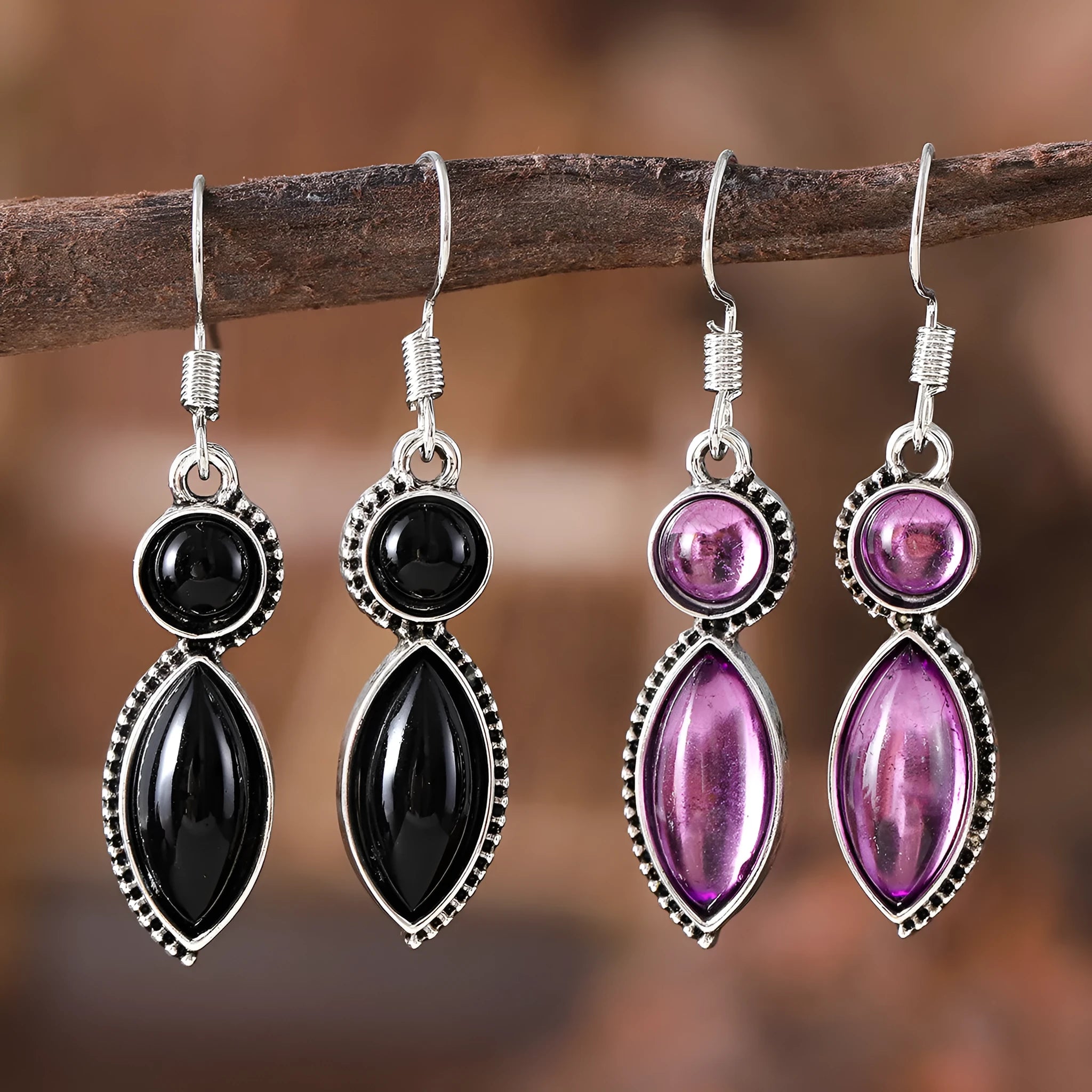 A pair of vintage-style geometric pendant earrings with purple and black stones on a zinc alloy frame.