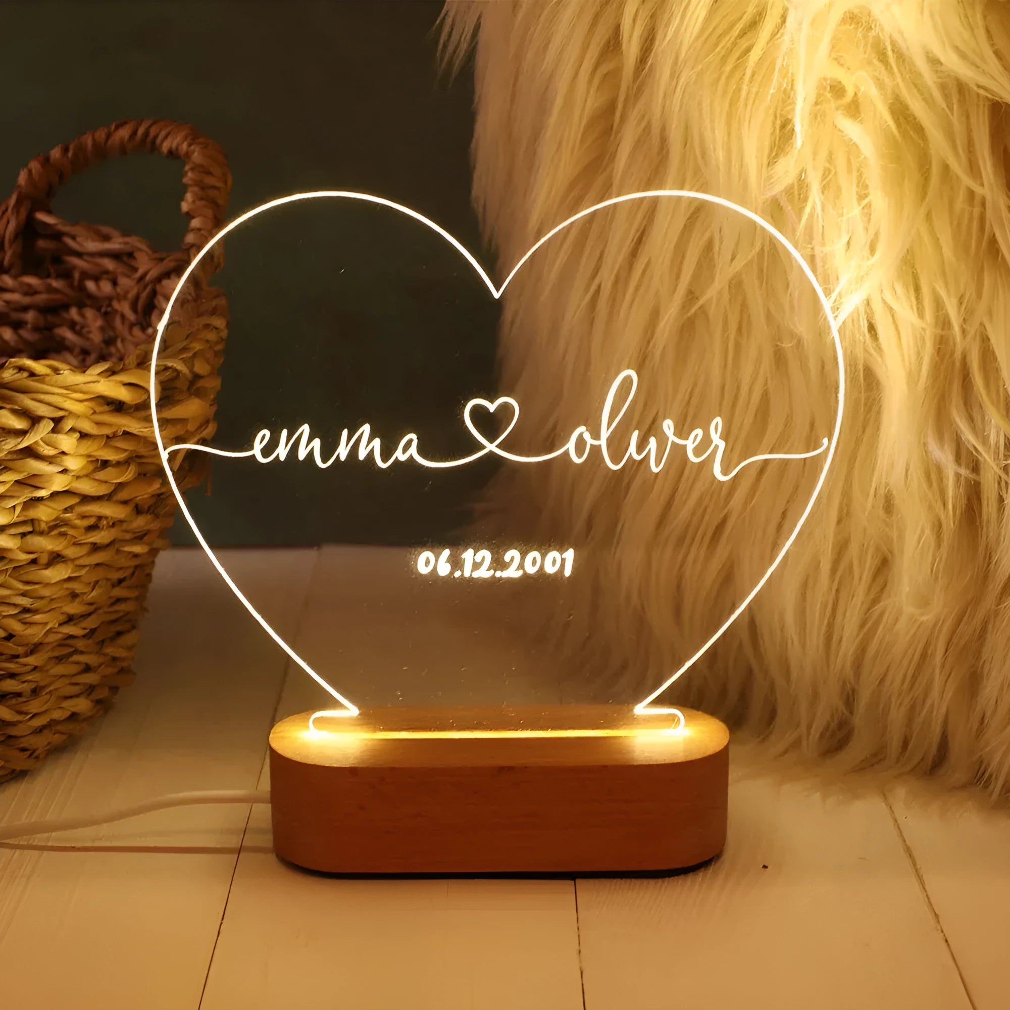 Custom clear acrylic night light displaying personalised names and date, lit by an LED base.