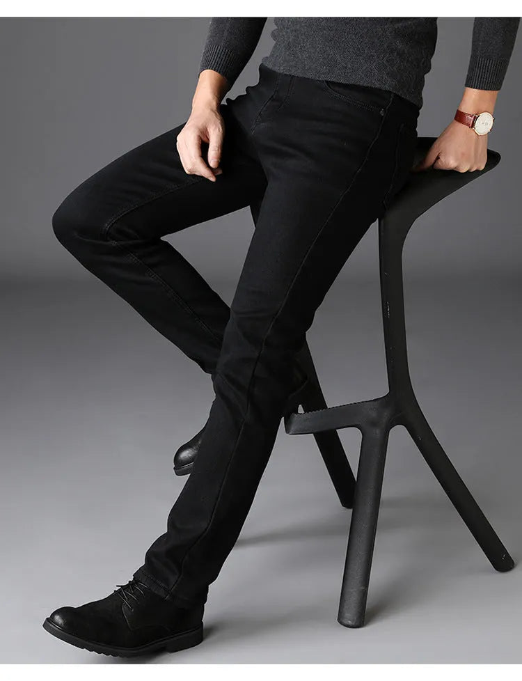Men's slim straight leg jeans in black cotton denim with mid waist and zip fly, sizes 28-40.