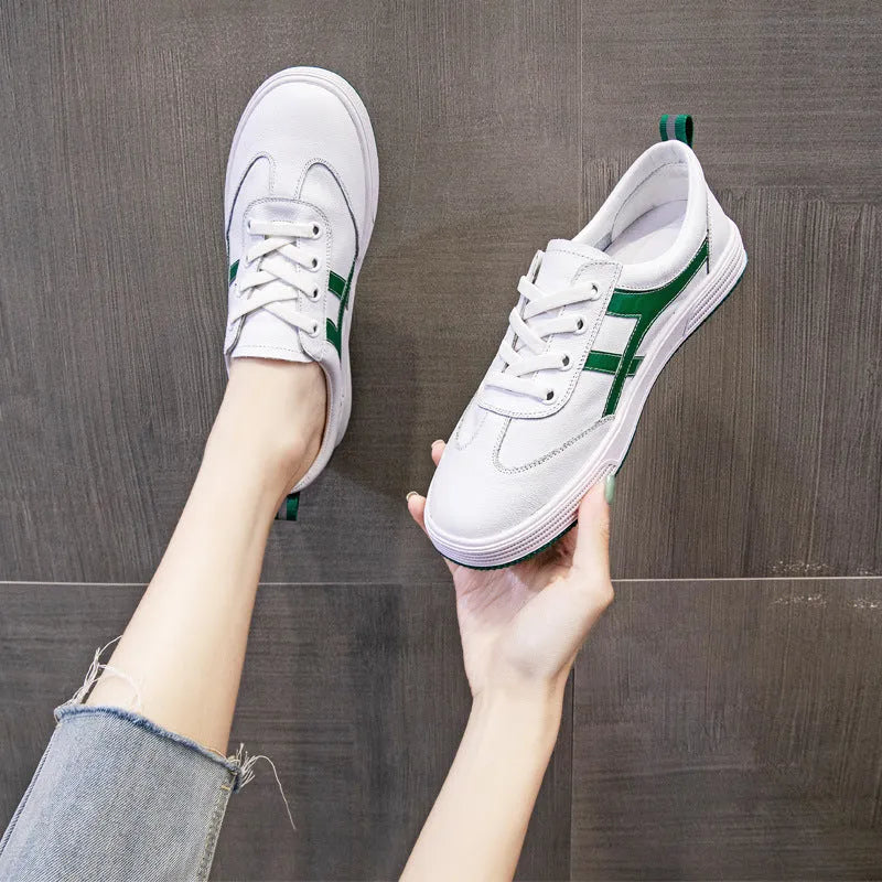Women's white and black leather sneakers with elastic band closure and round toe