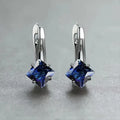 Women's copper earrings with inlaid zircon stones in a diamond design, colour option blue, on a white background