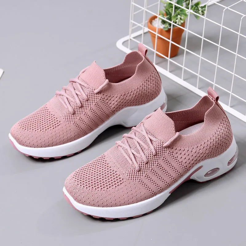 Women's black mesh lace-up sneakers with round toe and non-slip PVC sole on a white background.