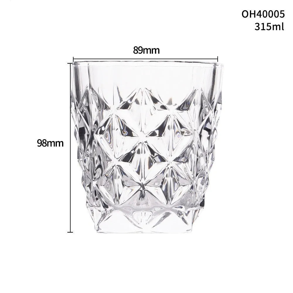 Clear crystal whiskey shot glass with thick bottom base on a table.