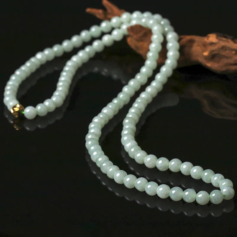 Adjustable natural jade bead necklace with 6.5mm round white and green beads on a long chain.