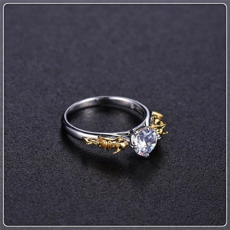 Close-up of a black gold copper ring with a detailed three-dimensional crown design on a finger.