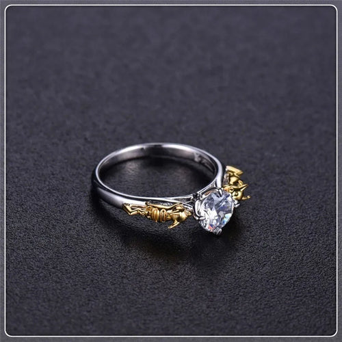 Close-up of a black gold copper ring with a detailed three-dimensional crown design on a finger.