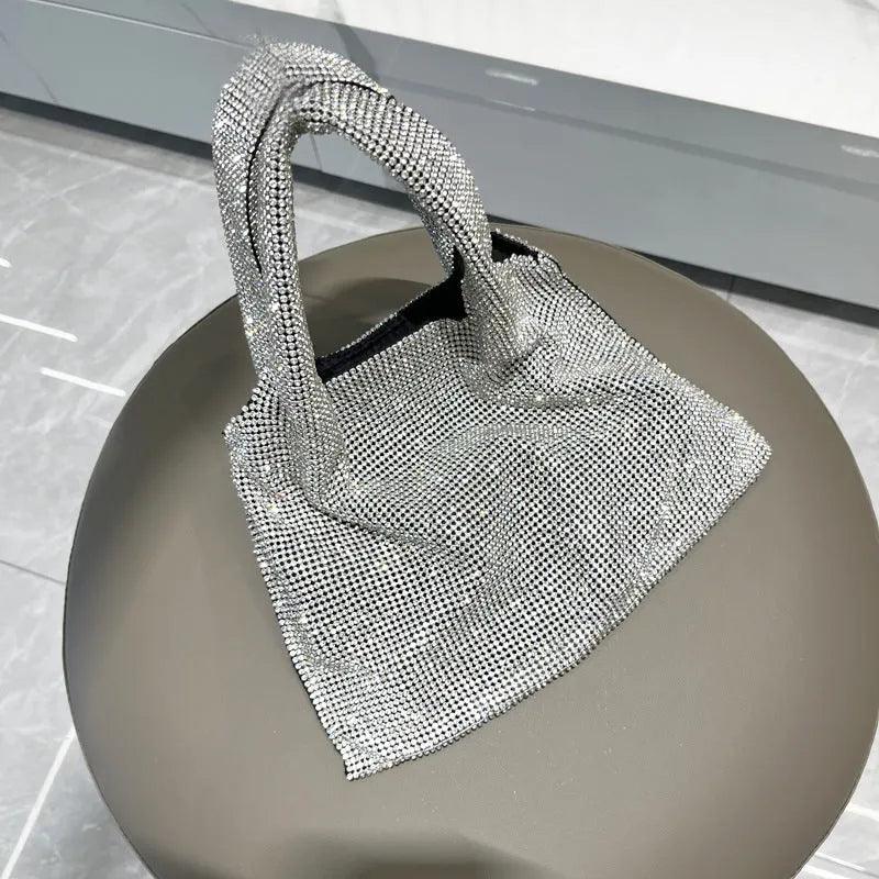 Silver cotton thread evening handbag with shiny rhinestone detailing and open outer pocket
