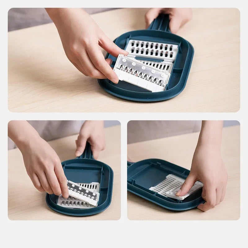 Dark blue manual vegetable cutter with four blades, hand guard, and drain basket on a kitchen counter