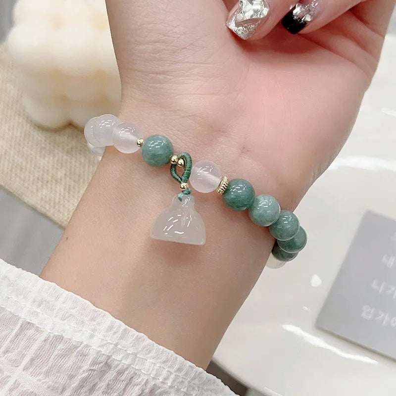 Close-up of a women's retro Chinese style agate bracelet with a carved lotus seedpod design.