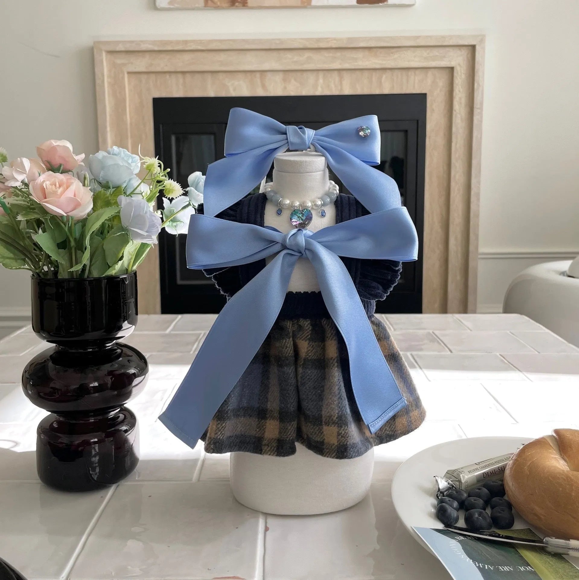 Blue princess style dog hair band with adjustable bow on a dog's head.