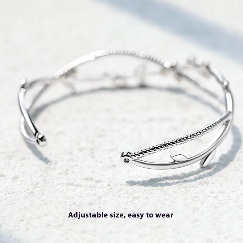 Cross twisted design branch sprout bracelet with white gold electroplated finish on copper