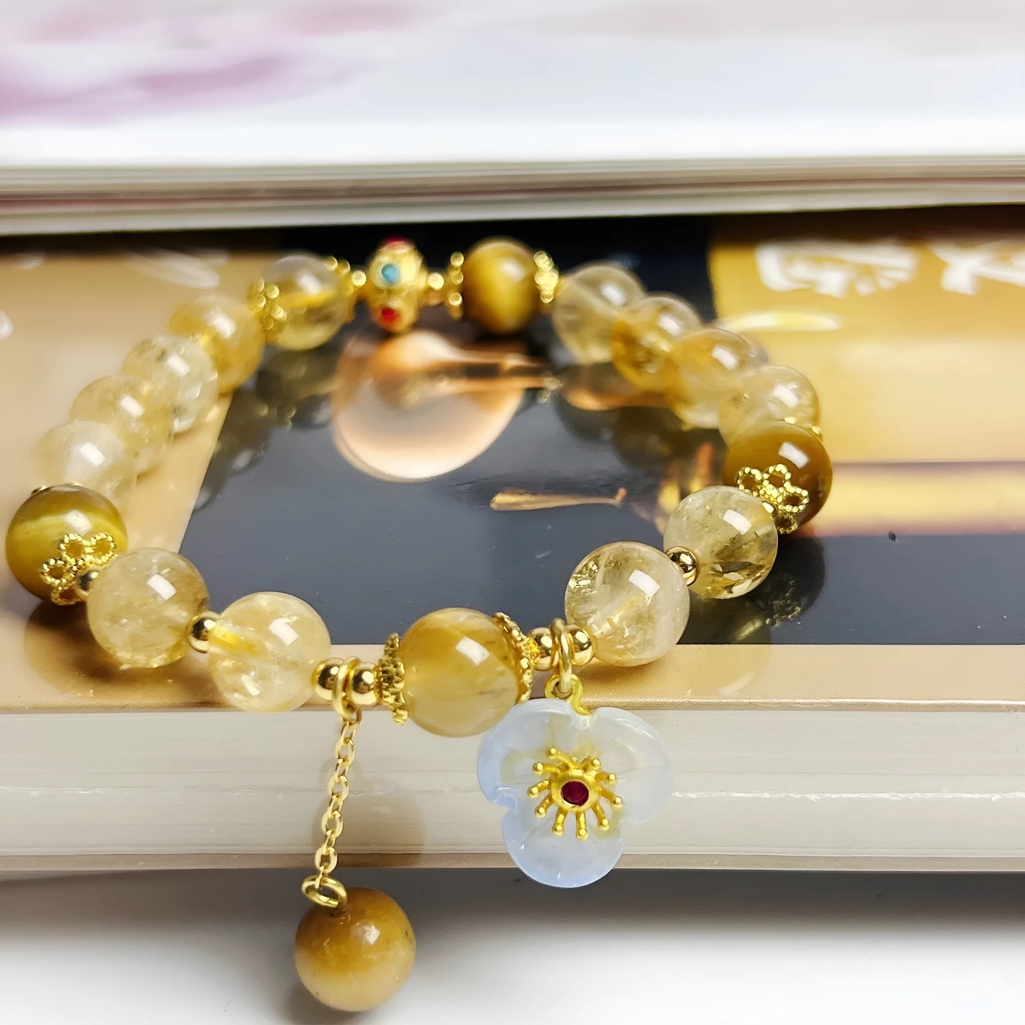 Handcrafted citrine crystal bracelet for women with a flower tassel in original design.