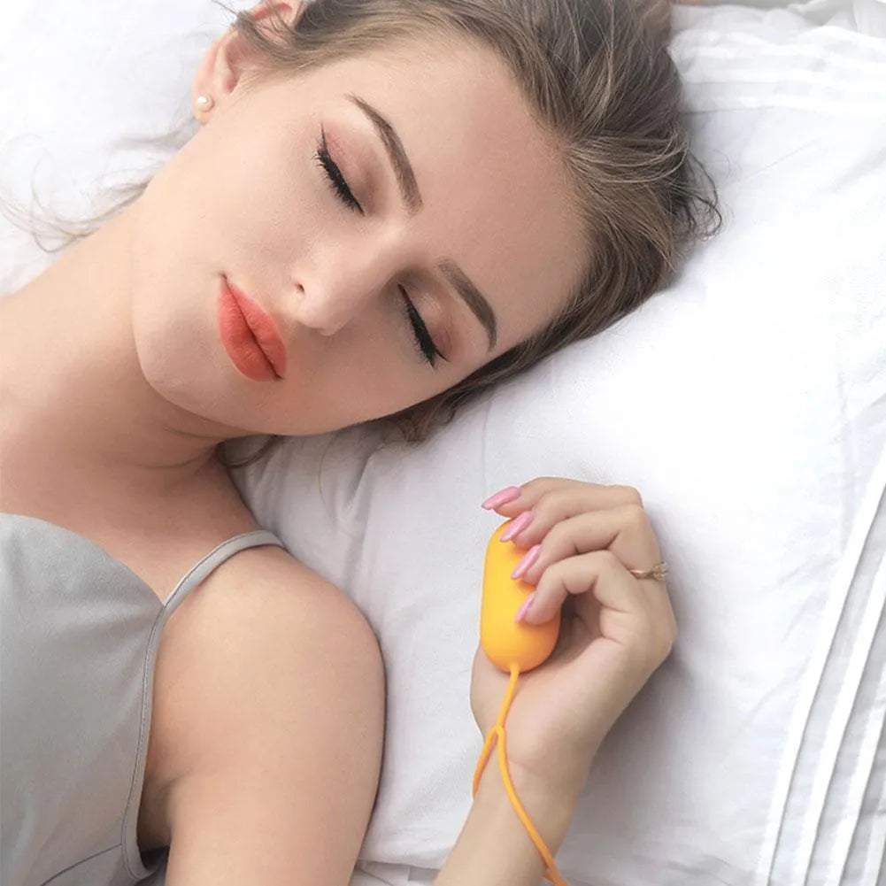 Handheld micro-current sleep aid device in grey colour with USB charging cable