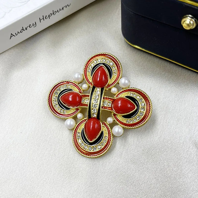 Close-up of a vintage medieval baroque style zinc alloy brooch with a crystal cross centrepiece.