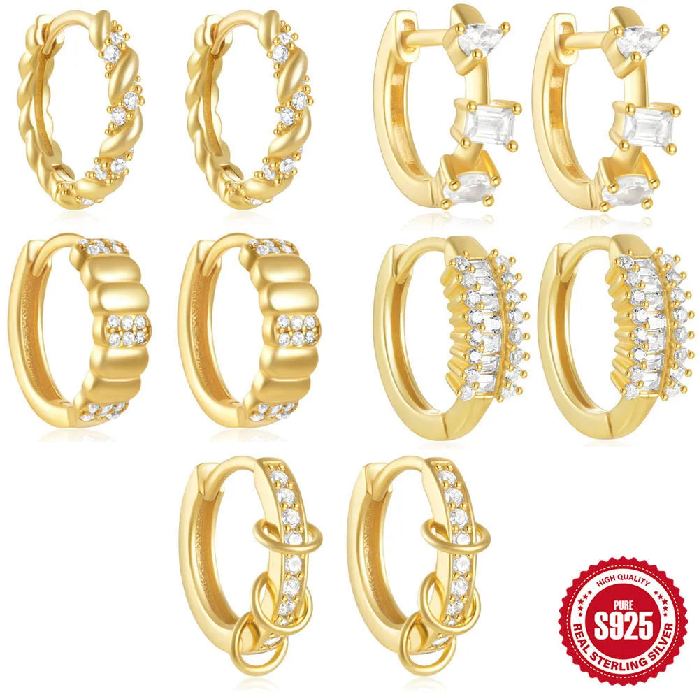 A pair of sterling silver geometric stud earrings with small round accents, shown in gold plating.