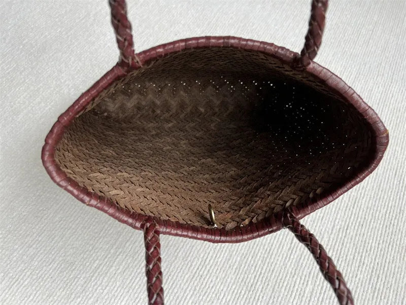 Brown handmade woven cowhide leather tote bag with a three-dimensional outer pocket.