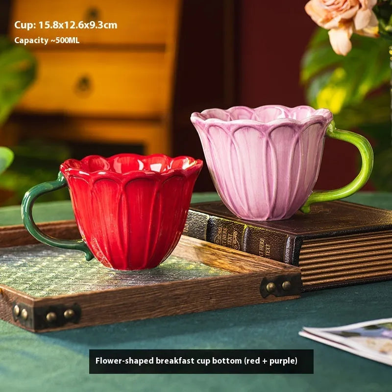 A red and purple floral ceramic cup with a 500ml capacity on a wooden table.