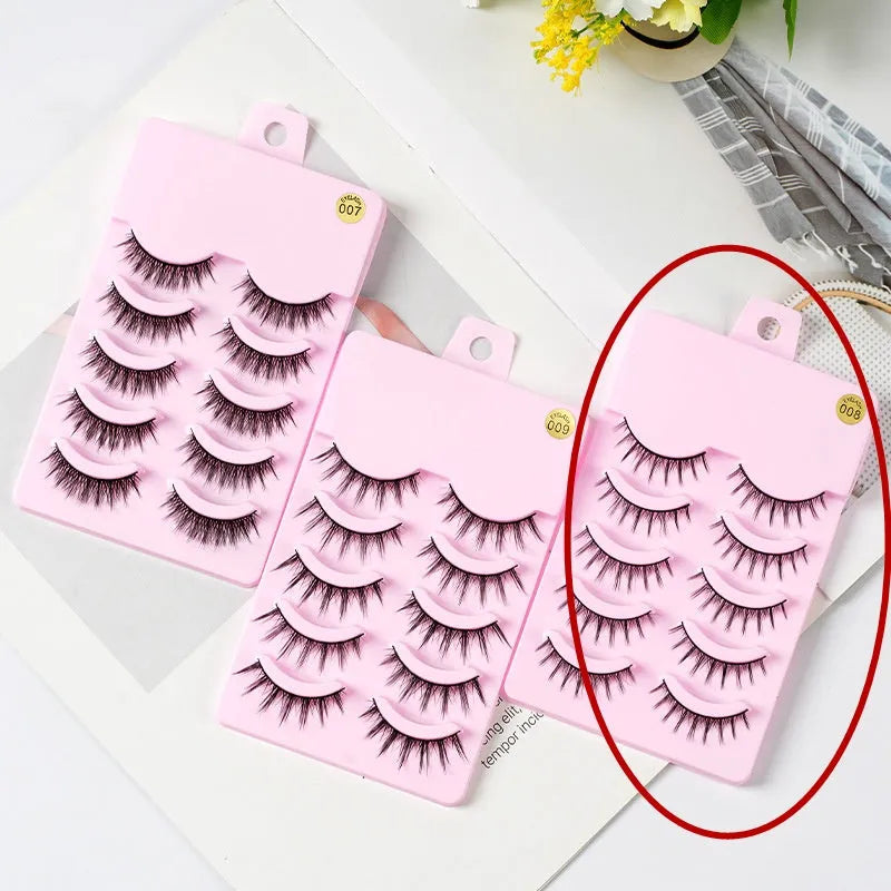Five pairs of black wispy manga false eyelashes on plastic bands, styles 007, 008, and 009 for anime cosplay.