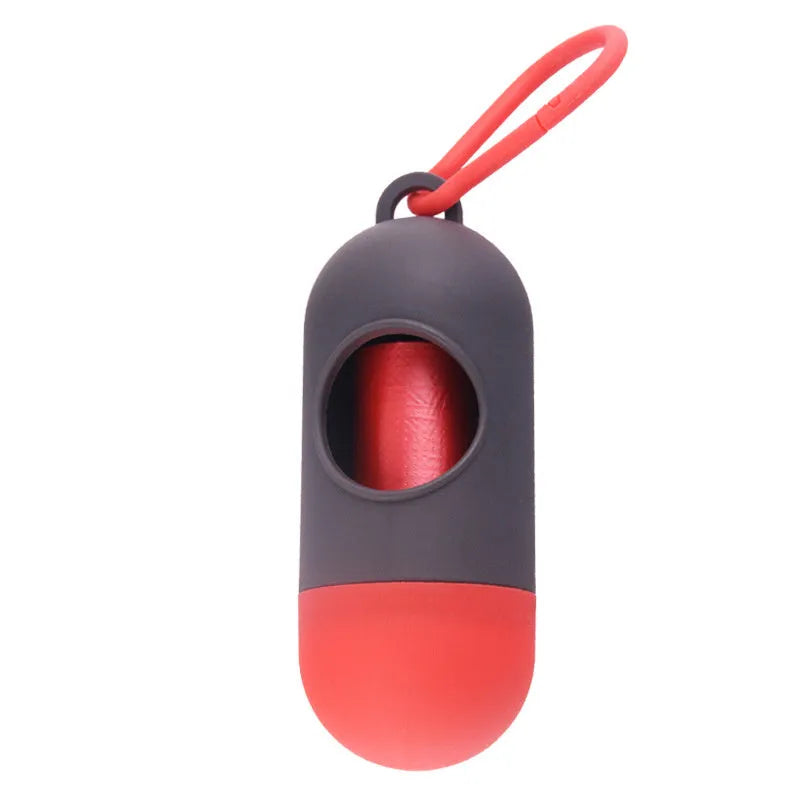 Black dog waste bag holder with Velcro strap and metal hook, showing bag dispenser slot.
