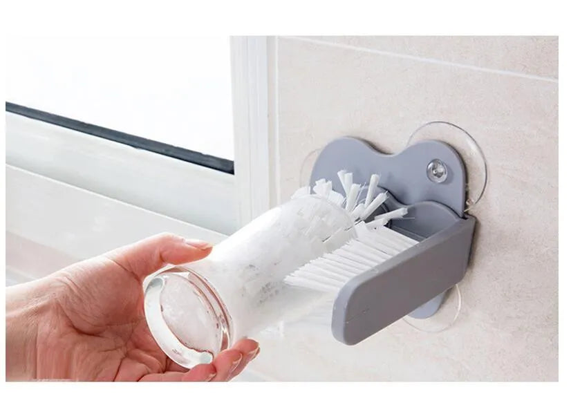 Grey rotating cup brush with dual heads and suction cups for wall mounting
