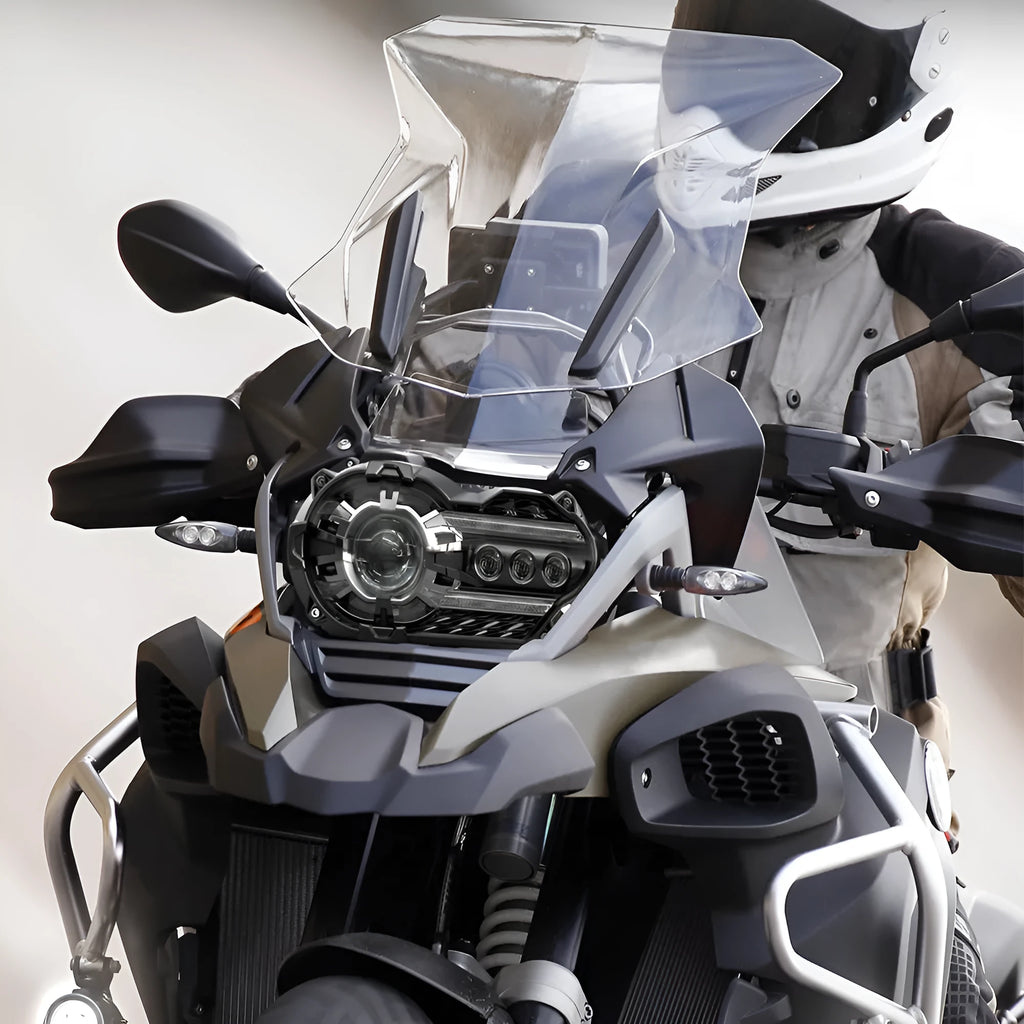 Black LED motorcycle headlight unit showing front lens and shell, with scale showing dimensions.