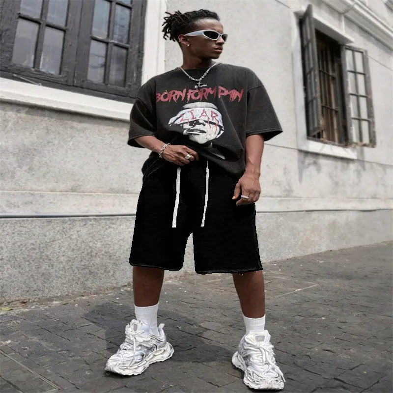 Men's straight-leg track trousers in black, shown in a casual streetwear style.