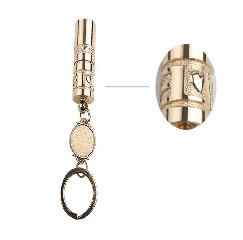 Gold-coloured zinc alloy mini LED flashlight on a keyring for outdoor and emergency use.