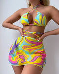Yellow striped women's halter swimsuit with lace-up front, worn with matching skirt and shorts.