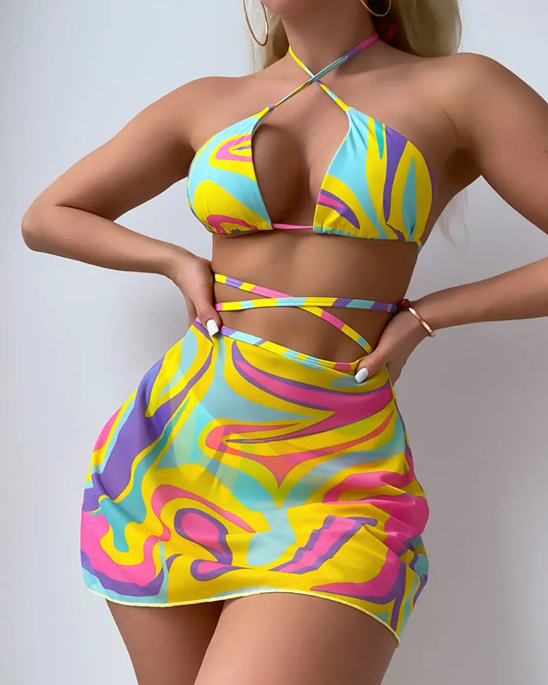 Yellow striped women's halter swimsuit with lace-up front, worn with matching skirt and shorts.