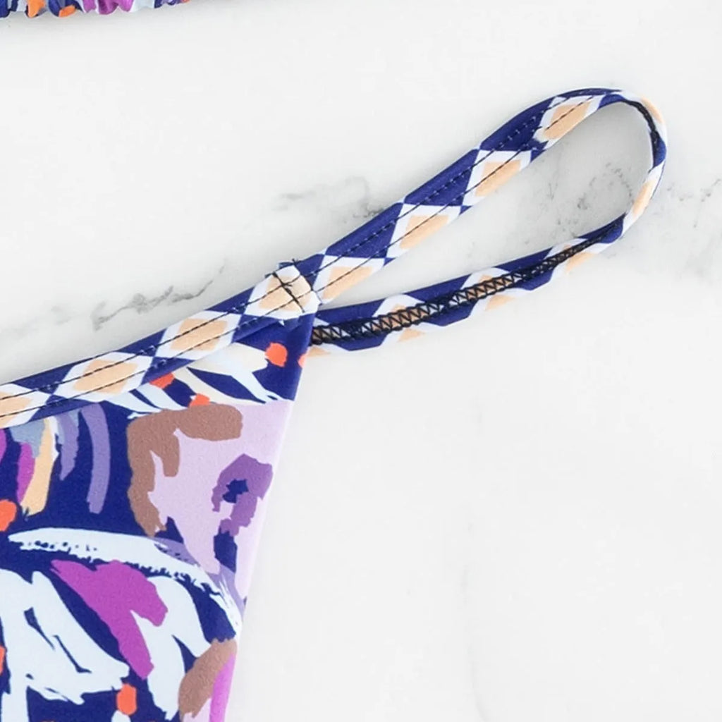 Women's floral print triangle top bikini swimsuit with briefs style bottoms in polyester fabric.