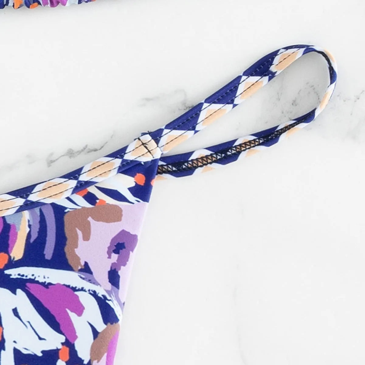 Women's floral print triangle top bikini swimsuit with briefs style bottoms in polyester fabric.