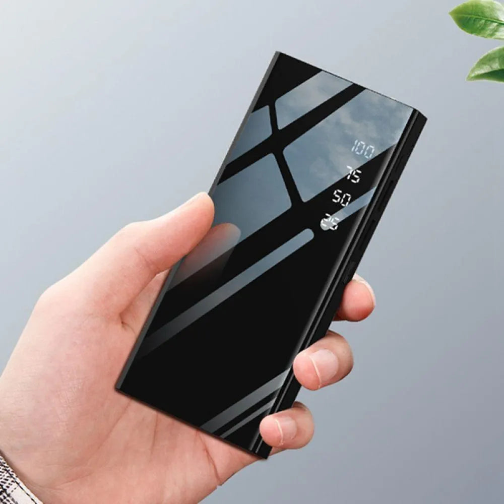 Black 20000mAh portable power bank showing LCD display and two USB ports.